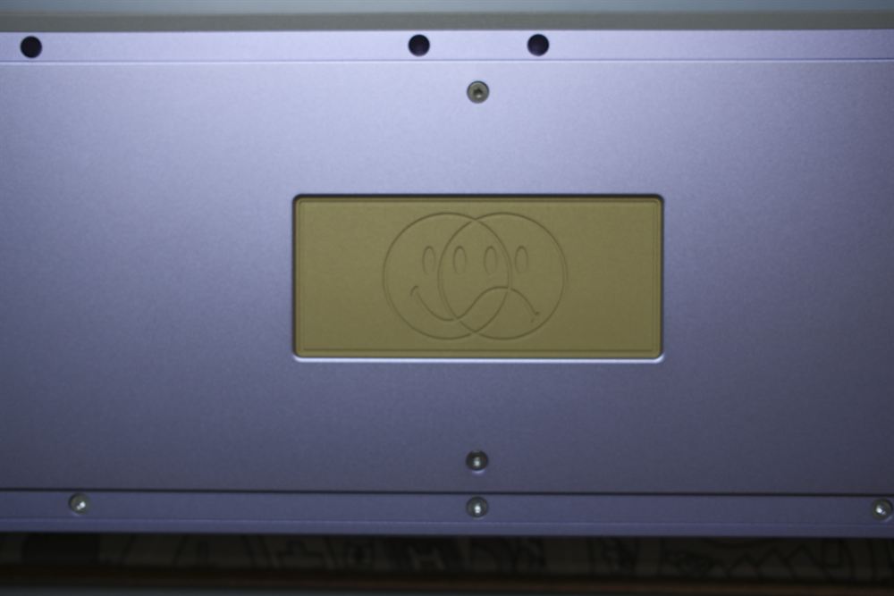 Underside detail of the brass weight and emblem