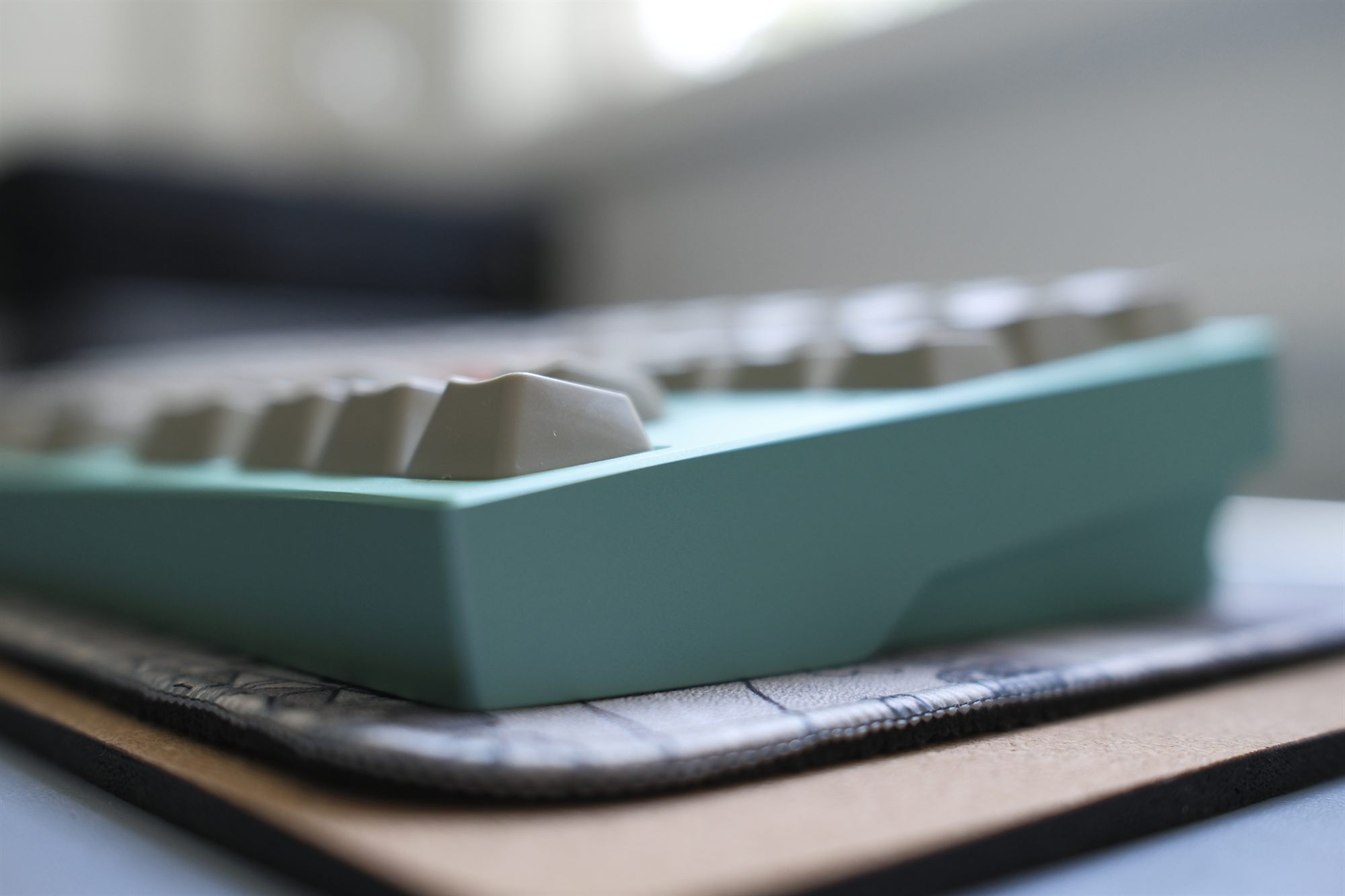 Daji Ocho Cuatro, atmospheric front-corner macro — seafoam case with beige and orange DCS keycaps