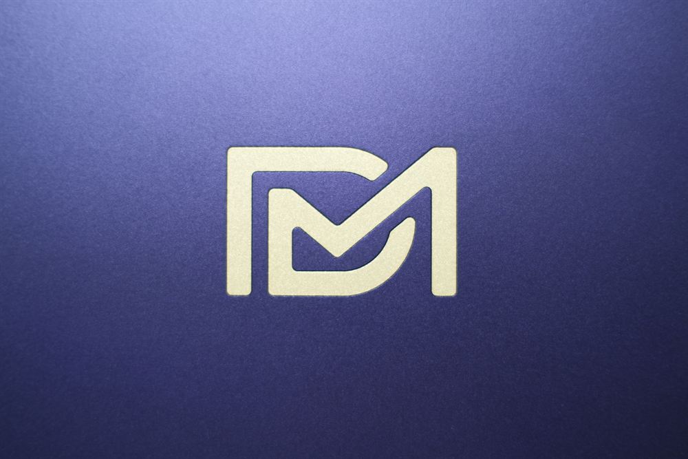 Extreme macro of the gold Drift Mechanics logo on purple