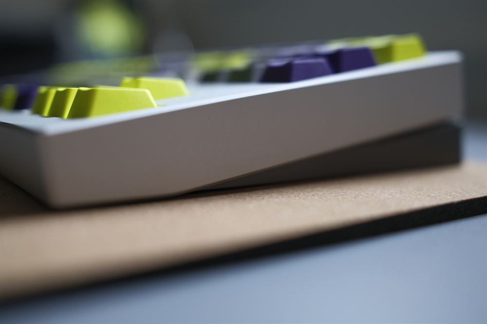 Side profile macro of the silver case with green and purple keys