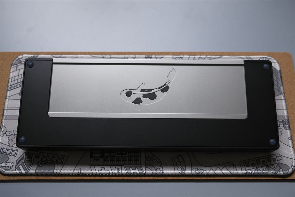 Top-down of the underside stainless weight with koi engraving