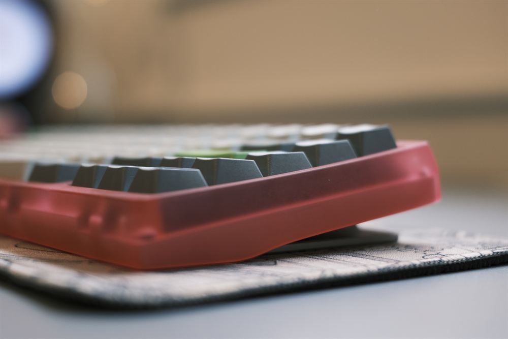 Front side profile with dark keycaps and soft bokeh