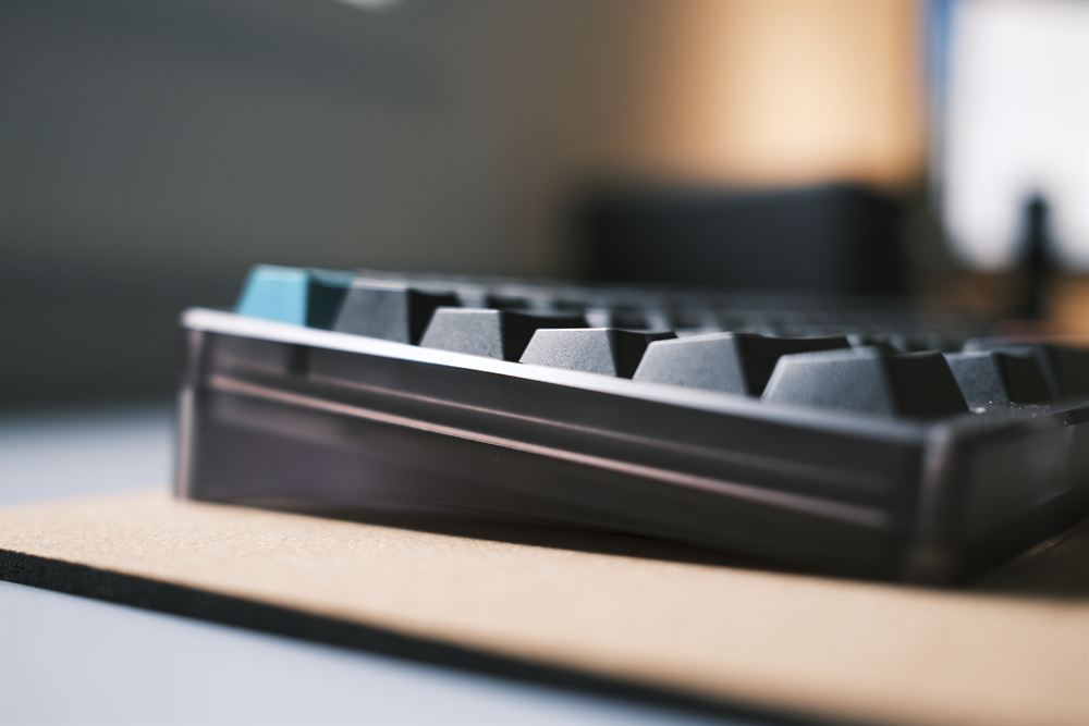 Low side angle with a teal accent keycap catching the light