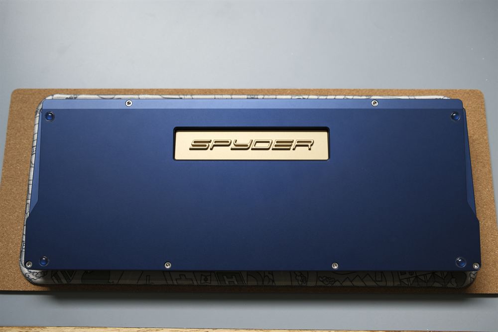 Underside of the blue case with the gold SPYDER weight