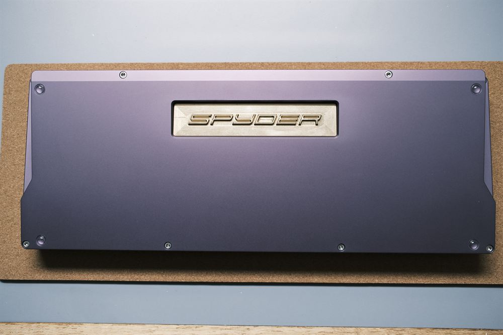 Underside of the case with the gold SPYDER weight