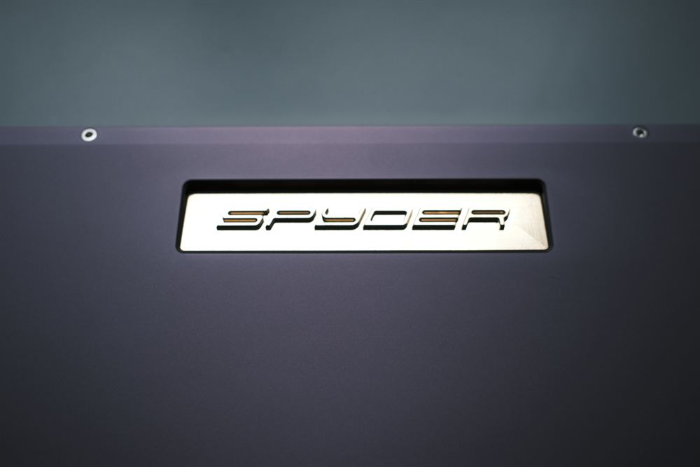 Macro of the engraved gold SPYDER nameplate