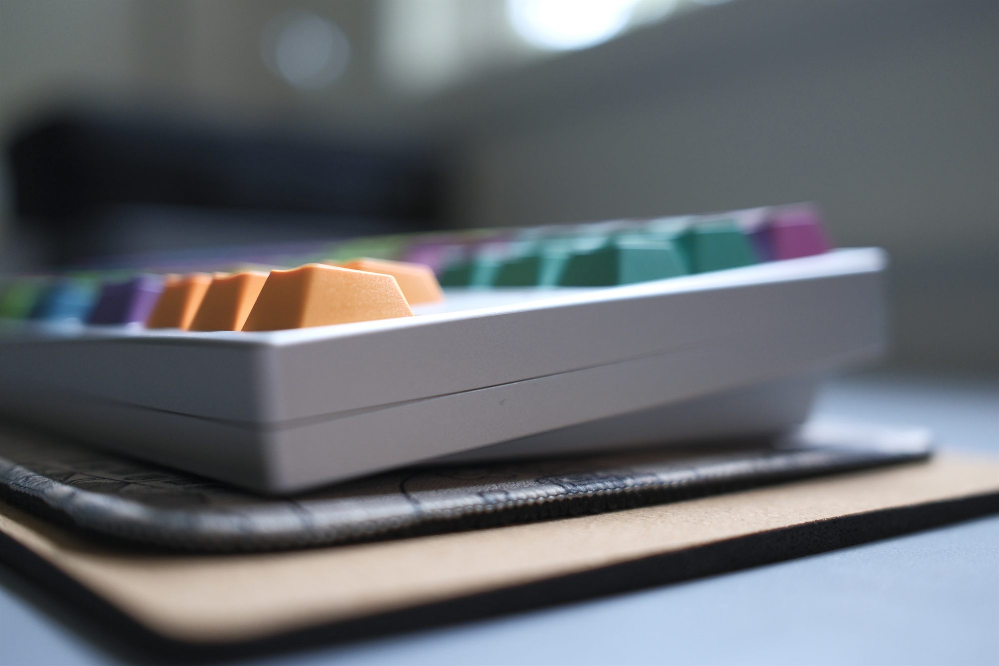 TGR Jane v2, side profile — silver anodized case with multicolor GMK Windbreaker keycaps and orange arrows