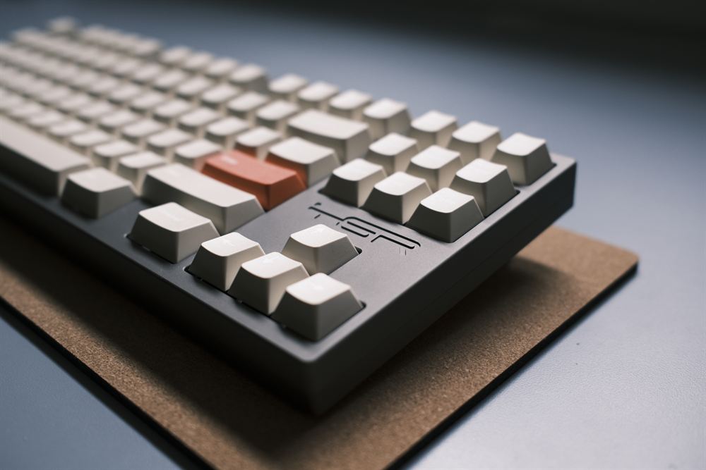 TGR Shi — gray case, bone keycaps, burnt-orange Enter