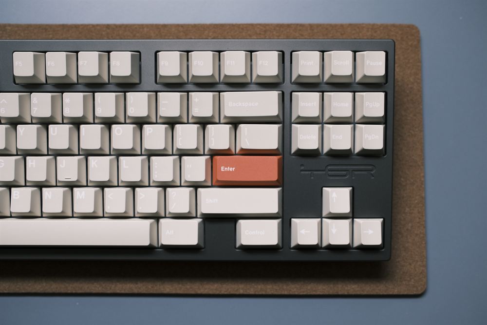 Top-down view of the TGR Shi showing GMK Stone keycaps and the engraved TGR logo