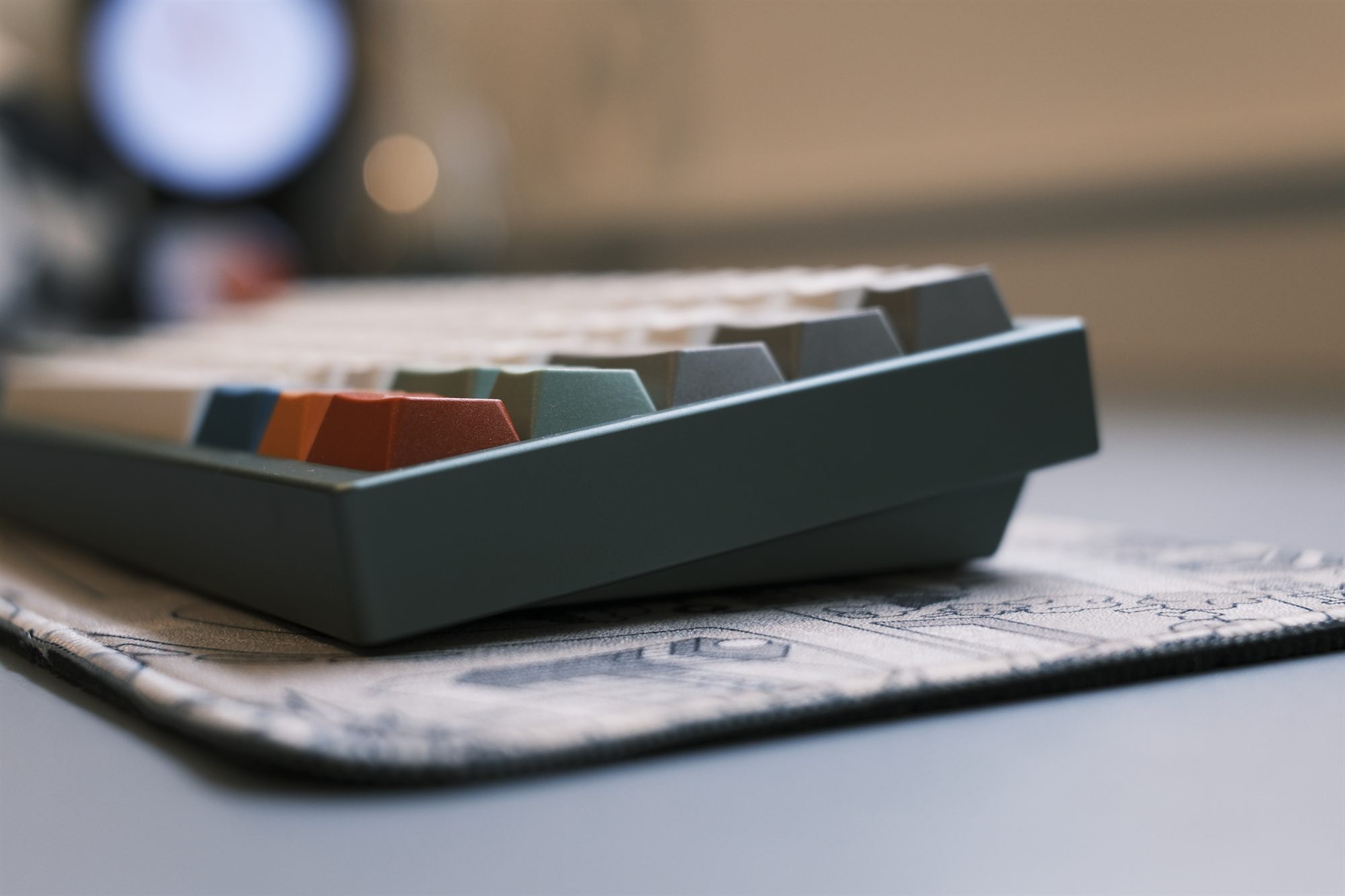 TGR x SingaKBD Unikorn, low three-quarter profile — reseda-green anodized case with cream GMK Foundation keycaps and colored accents