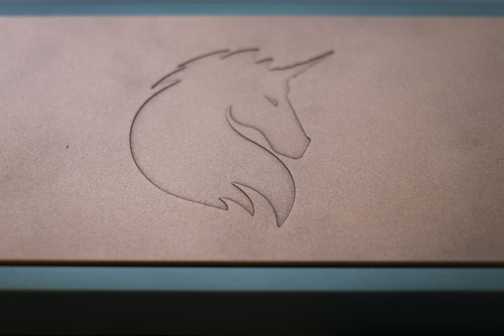 Macro of the unicorn logo etched into the copper weight